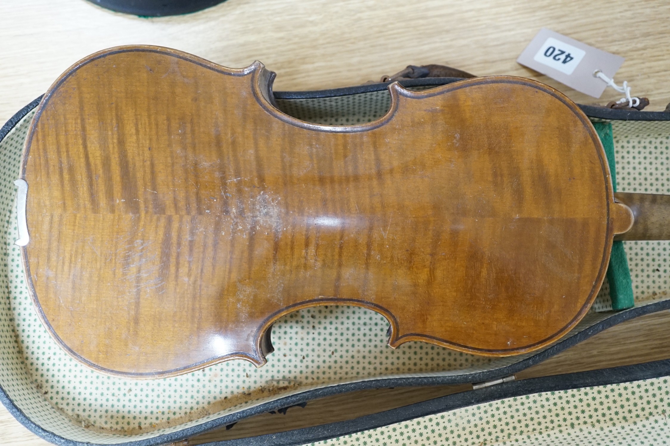 A cased violin, interior label reads ‘copy of Antonius Straduarius made in Germany’, back measures 35.5cm